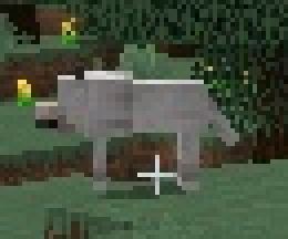 Zoomed crop of the pale animal, showing a muzzle and tail.